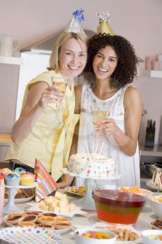 Royalty Free Photo of Two Women With Drinks at a Table of Food