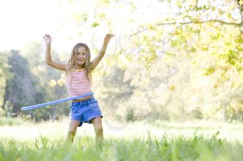 Royalty Free Photo of a Girl With a Hula Hoop