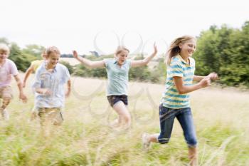 Royalty Free Photo of Kids Running in a Field