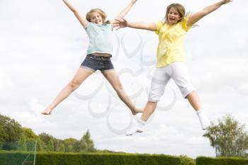 Royalty Free Photo of Two Girls on a Trampoline