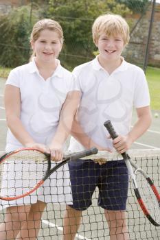 Royalty Free Photo of Two Children on a Tennis Court