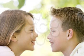 Royalty Free Photo of a Boy and Girl Looking at Each Other