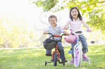Royalty Free Photo of a Brother and Sister on Bikes