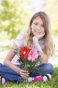 Royalty Free Photo of a Little Girl Holding Flowers