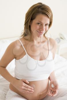 Royalty Free Photo of a Pregnant Woman Rubbing Her Belly