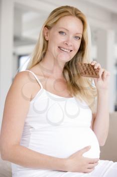 Royalty Free Photo of a Woman Eating a Chocolate Bar