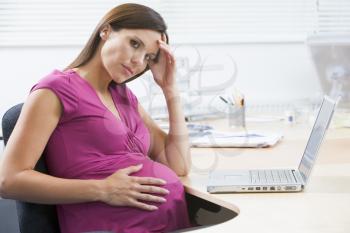 Royalty Free Photo of a Pregnant Woman at a Laptop