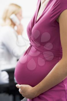 Royalty Free Photo of a Pregnant Woman in an Office