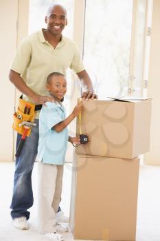 Royalty Free Photo of a Father and Son Beside Boxes