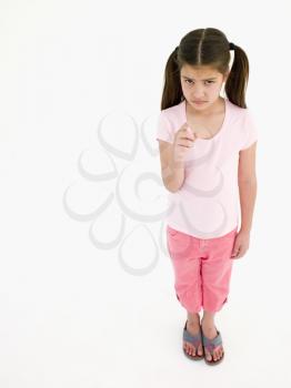Royalty Free Photo of a Little Girl Frowning and Pointing