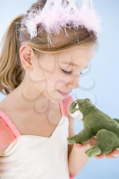 Royalty Free Photo of a Little Girl Kissing a Stuffed Frog
