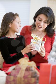 Royalty Free Photo of a Girl Giving Her Mom a Gift