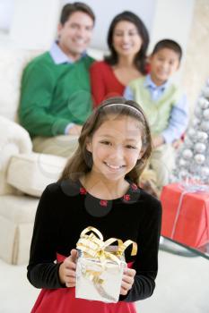 Royalty Free Photo of a Family With a Girl Holding a Gift
