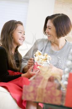 Royalty Free Photo of a Granddaughter Giving Her Grandmother a Gift