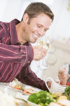 Royalty Free Photo of a Man Drinking Wine With Dinner