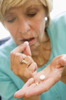 Royalty Free Photo of a Woman Taking Pills