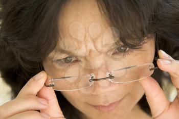 Royalty Free Photo of a Woman Wearing Glasses and Frowning