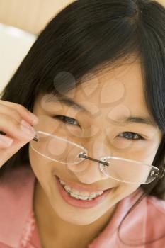 Royalty Free Photo of a Girl Looking Through Glasses