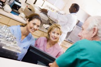 Royalty Free Photo of Hospital Personnel Talking at the Nurses Stations