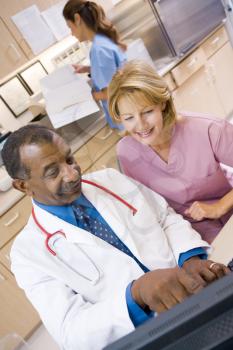 Royalty Free Photo of a Doctor and Nurse in the Reception Area