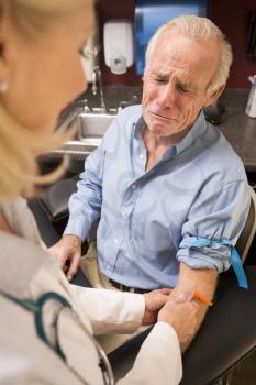 Royalty Free Photo of a Man Having a Blood Test Done