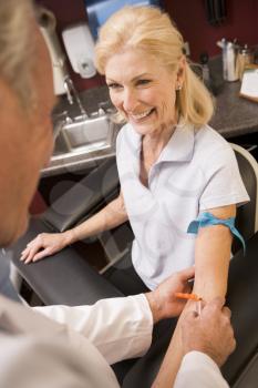 Royalty Free Photo of a Woman Having a Blood Test Done