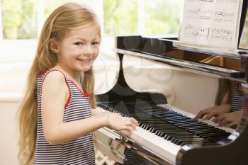 Royalty Free Photo of a Girl Playing Piano