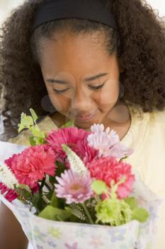 Royalty Free Photo of a Little Girl With a Bouquet of Flowers