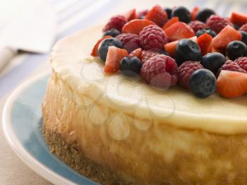 Royalty Free Photo of a New York Cheesecake With Mixed Berries