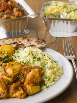 Royalty Free Photo of a Plate Of Indian Take Away- Chicken Bhoona, Sag Aloo, Pilau Rice And Naan Bread