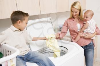 Royalty Free Photo of a Mother and Children Doing Laundry