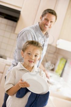 Royalty Free Photo of a Father and Son Doing Dishes