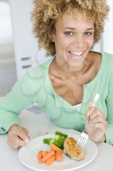 Royalty Free Photo of a Woman Eating a Meal