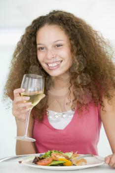 Royalty Free Photo of a Girl With a Glass of Wine and Dinner