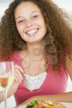 Royalty Free Photo of a Girl Having a Glass of Wine With Dinner