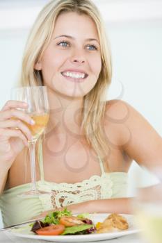 Royalty Free Photo of a Girl Having Wine With Dinner
