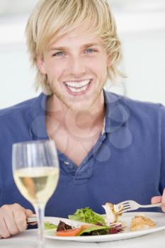 Royalty Free Photo of a Young Man Having Wine With Dinner