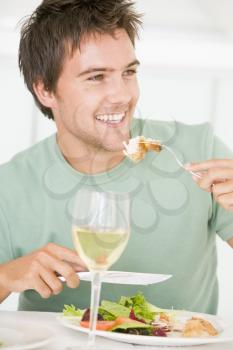 Royalty Free Photo of a Young Man Having Wine With Dinner