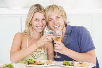 Royalty Free Photo of a Young Couple Having Wine With Dinner