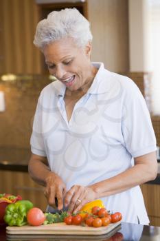 Royalty Free Photo of a Woman Chopping Vegetables