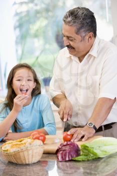 Royalty Free Photo of a Grandfather and Granddaughter Chopping Vegetables