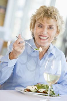 Royalty Free Photo of a Woman Having a Glass of Wine With Dinner