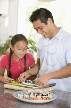 Royalty Free Photo of a Father and Daughter Preparing Sushi