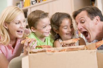 Royalty Free Photo of a Family Eating Pizza