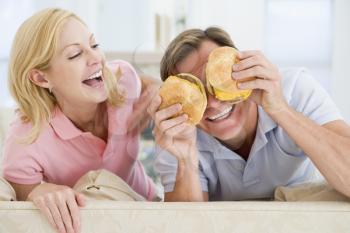 Royalty Free Photo of a Couple Eating Burgers