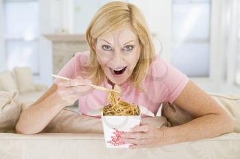 Royalty Free Photo of a Woman Eating Chinese Takeout