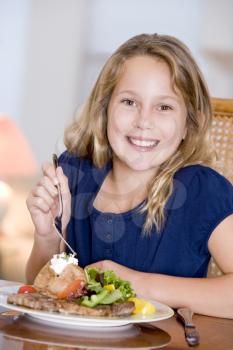 Royalty Free Photo of a Little Girl Eating Supper