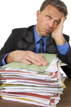 Royalty Free Photo of a Man Overwhelmed by Paperwork