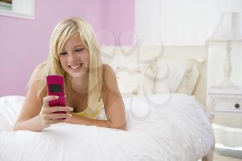 Royalty Free Photo of a Teenage Girl in Her Room With a Cellphone