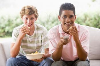 Royalty Free Photo of Boys Eating Crisps